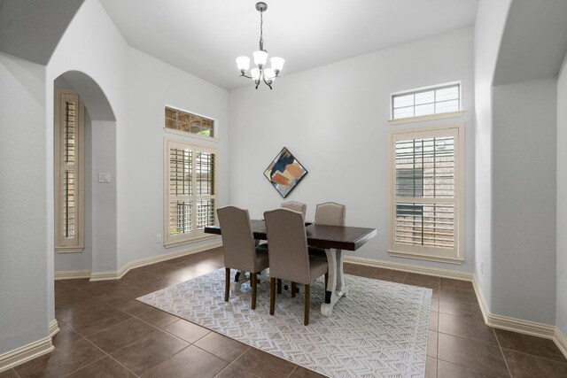 630 Wild Rose Dr, Austin, TX 78737 - dining room featuring plenty of natural light, dark tile patterned flooring, and a chandelier