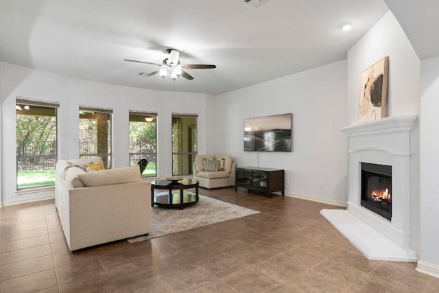 630 Wild Rose Dr, Austin, TX 78737 - living area with ceiling fan, a glass covered fireplace, and tile patterned flooring