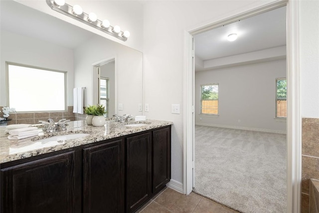 680 Peacock Ln, New Braunfels, TX 78130 - bathroom featuring double vanity, baseboards, and tile patterned flooring