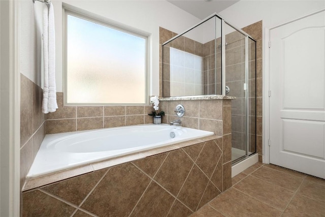 full bathroom with a shower stall, a garden tub, and tile patterned floors
