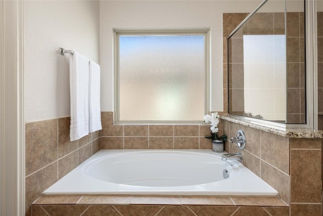 full bathroom featuring a garden tub and tiled shower