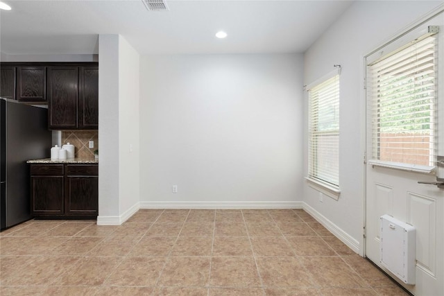unfurnished dining area with recessed lighting and baseboards