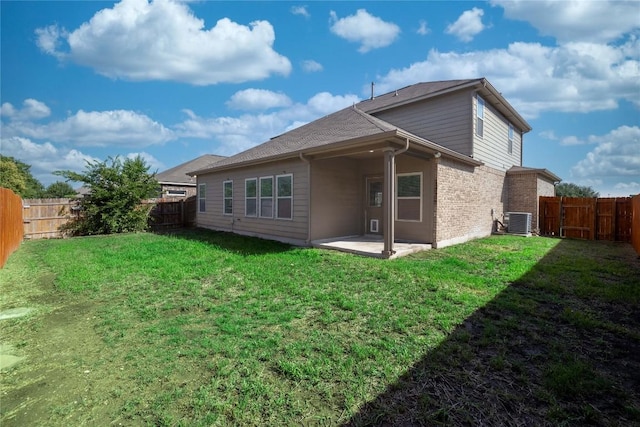 back of house featuring central AC, a patio, and brick siding