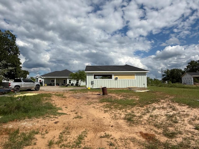 497 Brown Rd, Mcdade, TX 78650 - rear view of house featuring board and batten siding