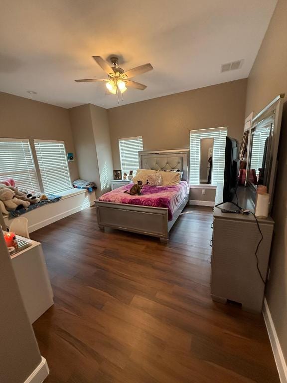 497 Brown Rd, Mcdade, TX 78650 - bedroom with dark wood-style floors, ceiling fan, and baseboards