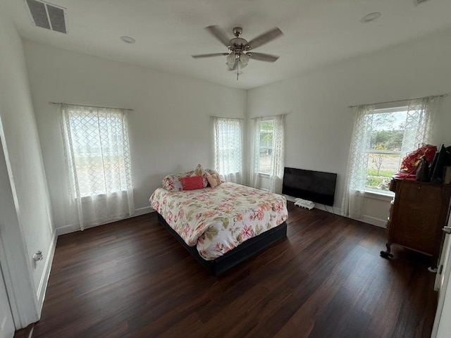497 Brown Rd, Mcdade, TX 78650 - bedroom with dark wood finished floors, baseboards, and a ceiling fan
