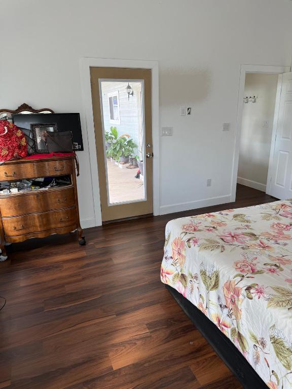 497 Brown Rd, Mcdade, TX 78650 - bedroom featuring dark wood finished floors and baseboards