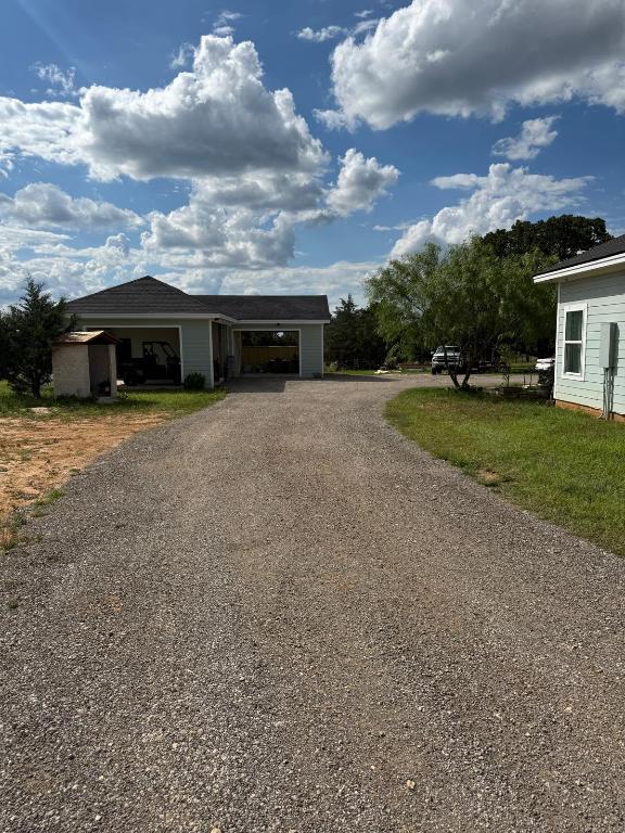 497 Brown Rd, Mcdade, TX 78650 - view of front of property with driveway and an outbuilding
