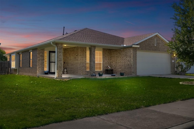 204 Mossberg Ln, Bastrop, TX 78602 - ranch-style house featuring a garage, a front lawn, and brick siding