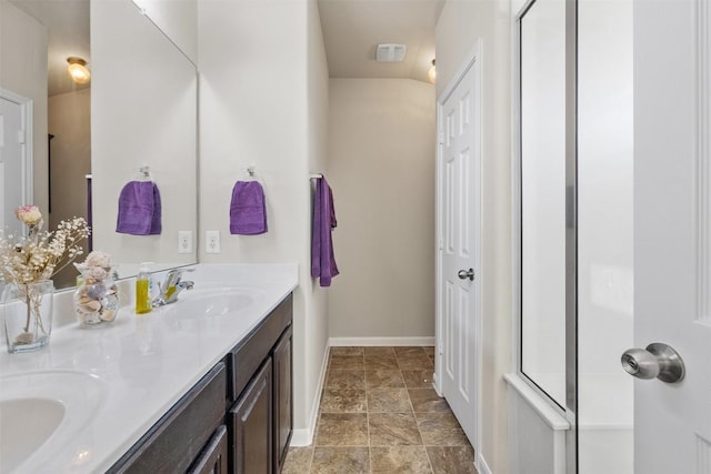 204 Mossberg Ln, Bastrop, TX 78602 - full bath featuring double vanity, baseboards, stone finish flooring, and a shower with shower door