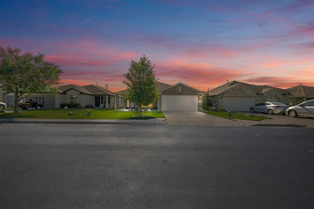 204 Mossberg Ln, Bastrop, TX 78602 - ranch-style house featuring a residential view, concrete driveway, an attached garage, and a lawn