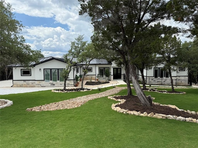 rear view of house with french doors, stucco siding, and stone siding