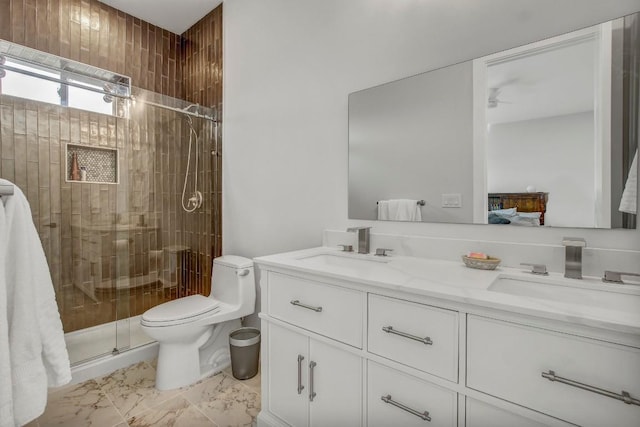 ensuite bathroom featuring double vanity, a shower stall, toilet, a ceiling fan, and marble finish flooring