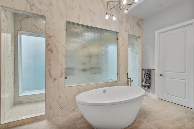 full bathroom featuring a marble finish shower and a freestanding tub