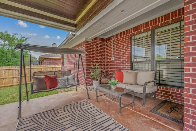 view of patio / terrace with an outdoor hangout area and fence