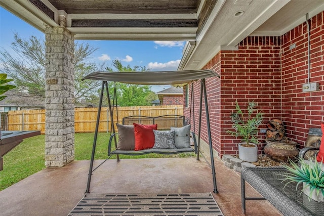 view of patio featuring fence