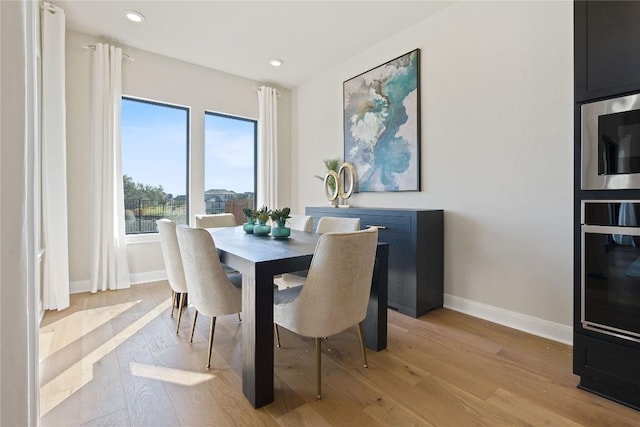1300 Shelby Ln, Georgetown, TX 78628 - dining space with baseboards, light wood-style floors, and recessed lighting