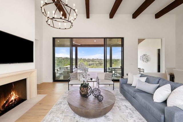 12625 Maidenhair Ln Unit 31, Austin, TX 78738 - living area with light wood-style floors, a chandelier, beamed ceiling, baseboards, and a fireplace with flush hearth