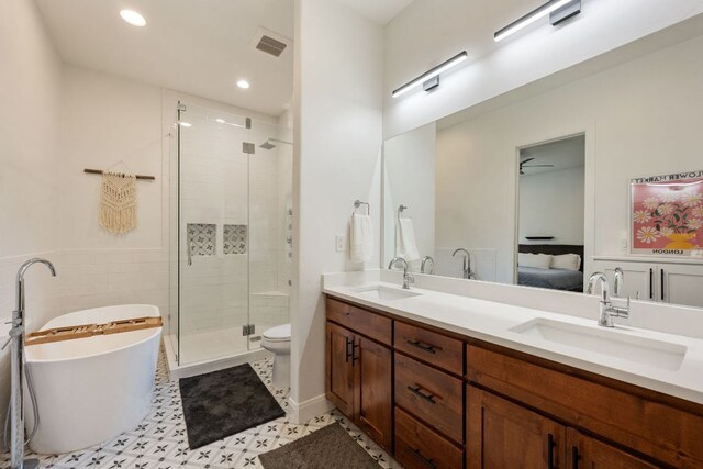 124 Hoskins Trl, Boerne, TX 78006 - bathroom with double vanity, a soaking tub, a shower stall, recessed lighting, and ensuite bathroom