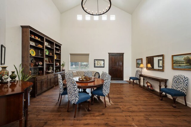 124 Hoskins Trl, Boerne, TX 78006 - dining area with high vaulted ceiling, a chandelier, dark wood-type flooring, and baseboards
