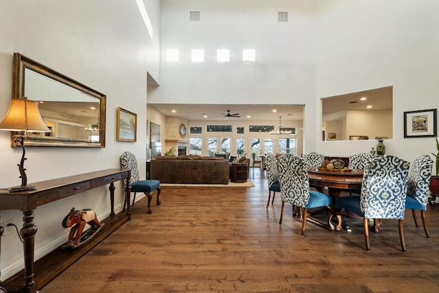 124 Hoskins Trl, Boerne, TX 78006 - dining space featuring wood finished floors, a towering ceiling, a ceiling fan, and recessed lighting