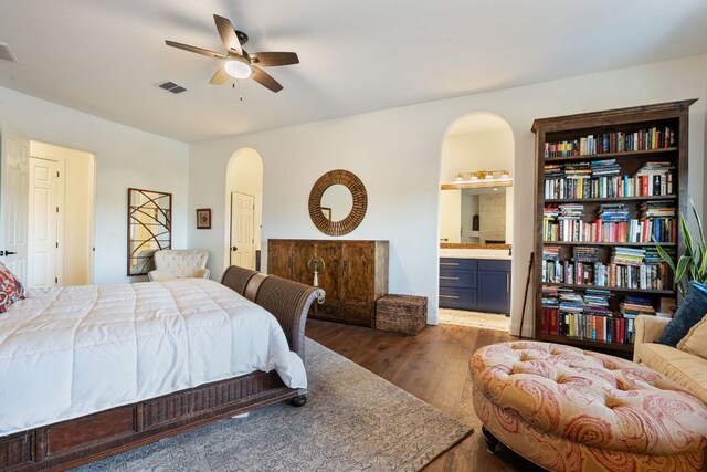 124 Hoskins Trl, Boerne, TX 78006 - bedroom featuring arched walkways, wood finished floors, ensuite bathroom, and ceiling fan