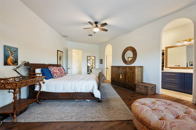 124 Hoskins Trl, Boerne, TX 78006 - bedroom featuring arched walkways, wood finished floors, ensuite bathroom, and ceiling fan