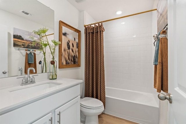552 Tekoa Dr, Georgetown, TX 78628 - bathroom featuring toilet, vanity, shower / bath combo with shower curtain, and wood finished floors