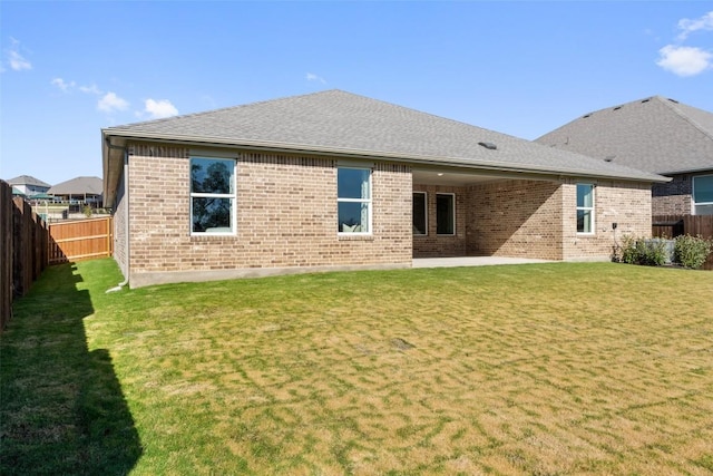 552 Tekoa Dr, Georgetown, TX 78628 - rear view of property with brick siding, roof with shingles, and a patio area