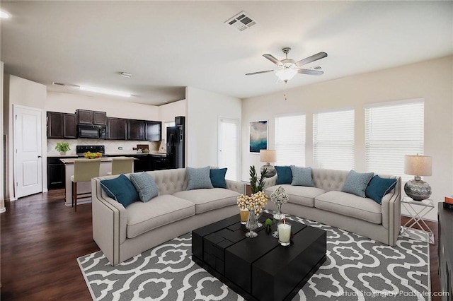 living room with a ceiling fan and dark wood-style flooring