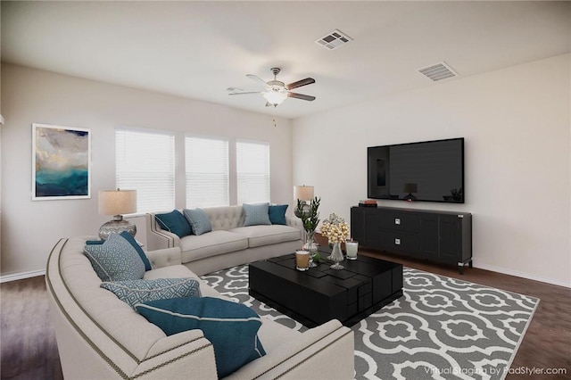 living room with ceiling fan, baseboards, and wood finished floors