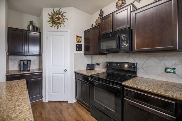 kitchen featuring black appliances, dark brown cabinetry, dark wood finished floors, tasteful backsplash, and light stone counters