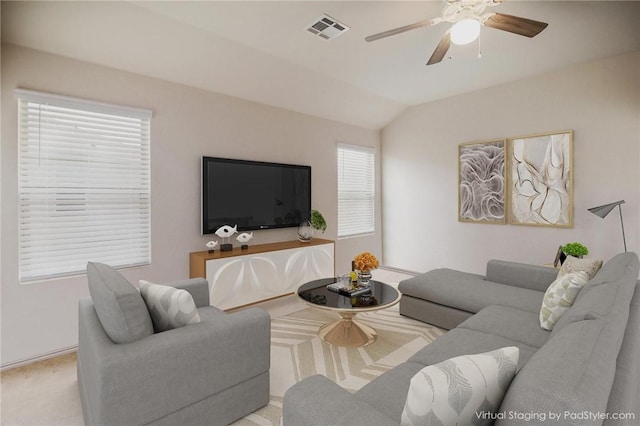carpeted living area with ceiling fan and lofted ceiling