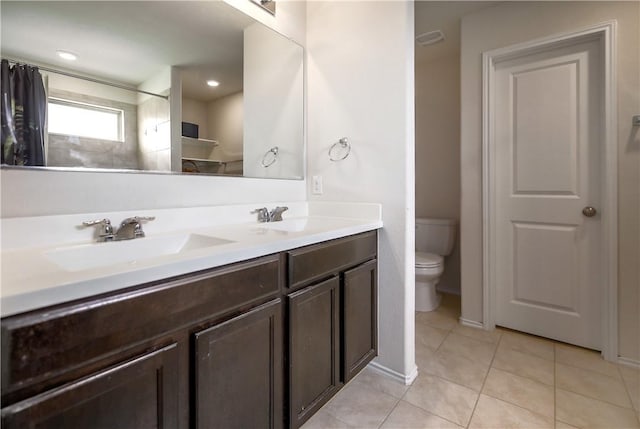 full bath with toilet, tile patterned floors, double vanity, and a shower