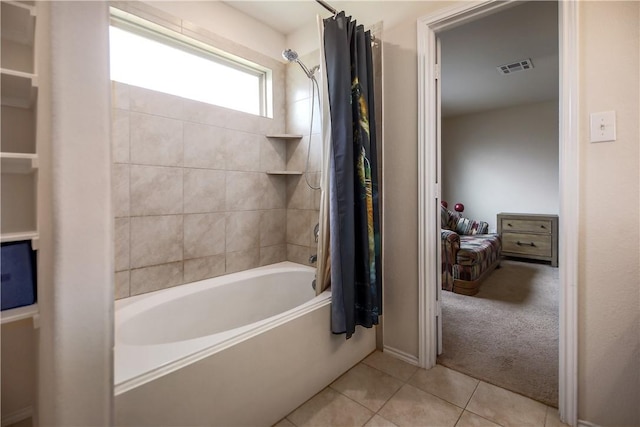 bathroom featuring tile patterned floors, shower / tub combo, and baseboards