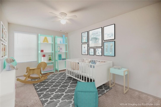 bedroom featuring carpet flooring, a crib, and ceiling fan
