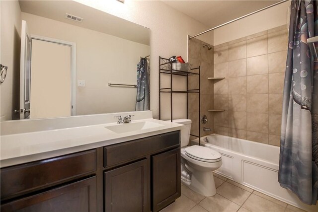 bathroom with tile patterned floors, shower / tub combo, toilet, and vanity