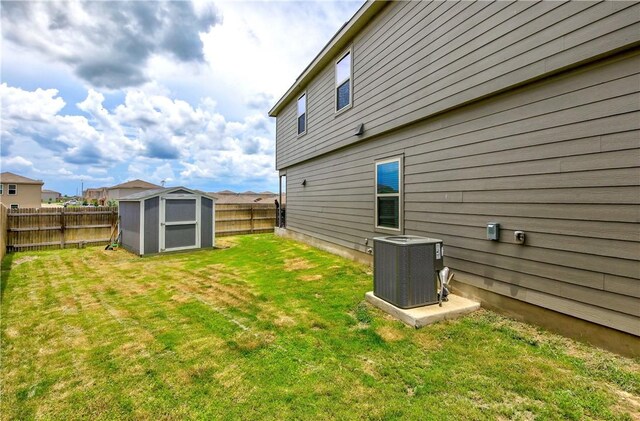 back of property with central AC unit, a storage unit, and an outdoor structure