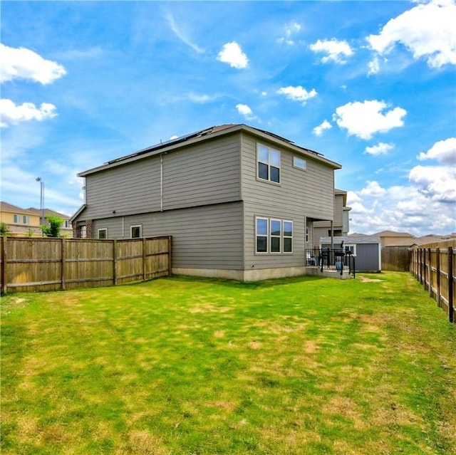 rear view of house featuring a shed and an outdoor structure
