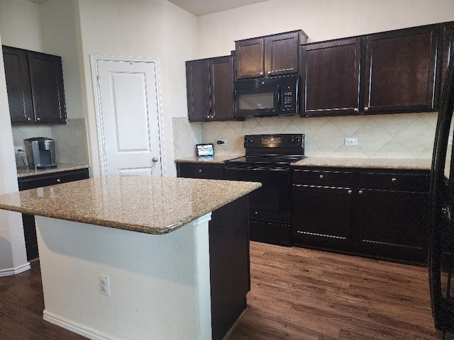 428 Major Lee Ln Unit 10H, Jarrell, TX 76537 - kitchen with black appliances, dark wood-style flooring, light stone counters, backsplash, and a kitchen island