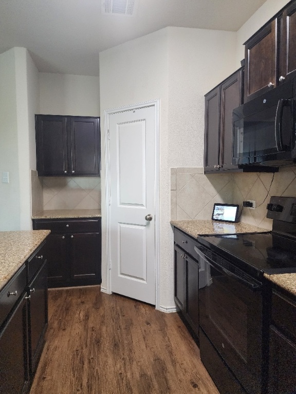 428 Major Lee Ln Unit 10H, Jarrell, TX 76537 - kitchen featuring black appliances, dark wood-type flooring, and decorative backsplash