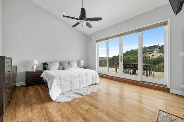 bedroom featuring access to outside, wood finished floors, baseboards, ceiling fan, and high vaulted ceiling