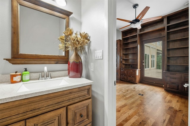 5801 Cannonade Ct, Austin, TX 78746 - bathroom featuring wood finished floors, vanity, built in features, and ceiling fan