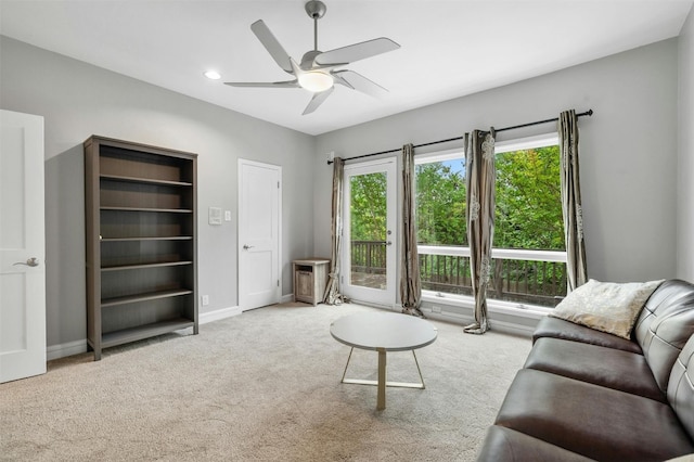 carpeted living room with a ceiling fan, baseboards, and recessed lighting