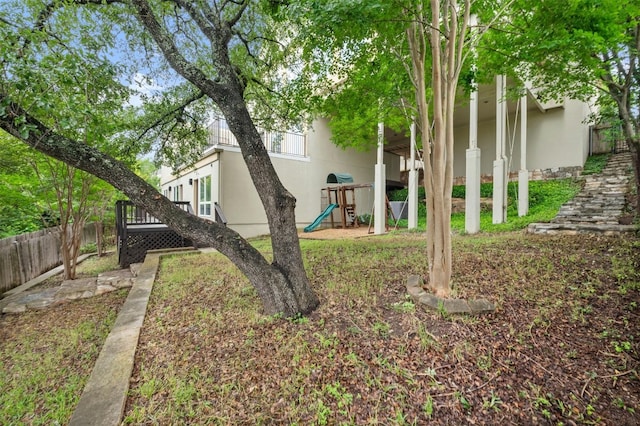 view of yard featuring a playground and fence