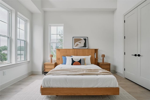 2209 Woodland Ave Unit 501, Austin, TX 78741 - bedroom with light wood finished floors and baseboards