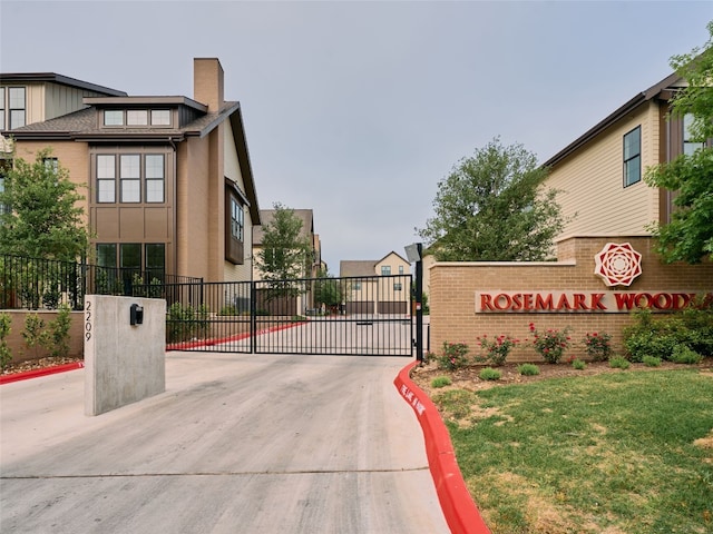 2209 Woodland Ave Unit 501, Austin, TX 78741 - view of concrete street with curbs, a gated entry, and a gate