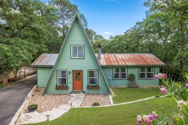 113 S Kanaio Dr, Bastrop, TX 78602 - a-frame style home featuring a front lawn and metal roof