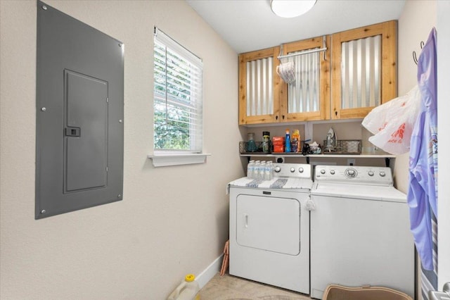 113 S Kanaio Dr, Bastrop, TX 78602 - washroom featuring electric panel, washing machine and dryer, cabinet space, and baseboards