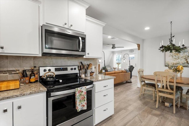 113 S Kanaio Dr, Bastrop, TX 78602 - kitchen featuring stainless steel appliances, white cabinets, backsplash, ceiling fan, and recessed lighting